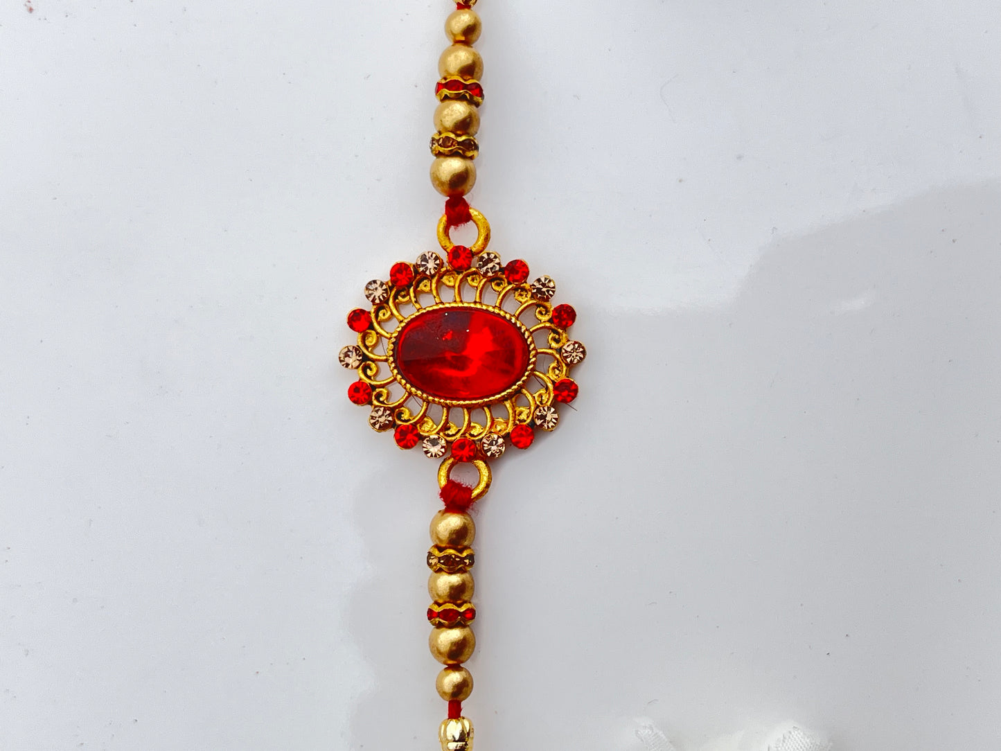 RED ZIRCON OVAL RAKHI