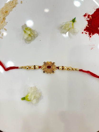 GOLDEN FLOWER RED STONE RAKHI