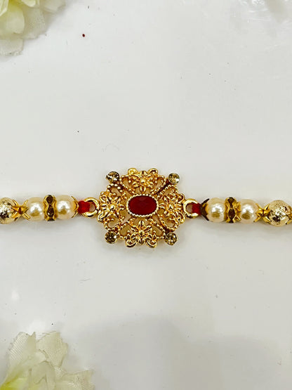 GOLDEN FLOWER RED STONE RAKHI